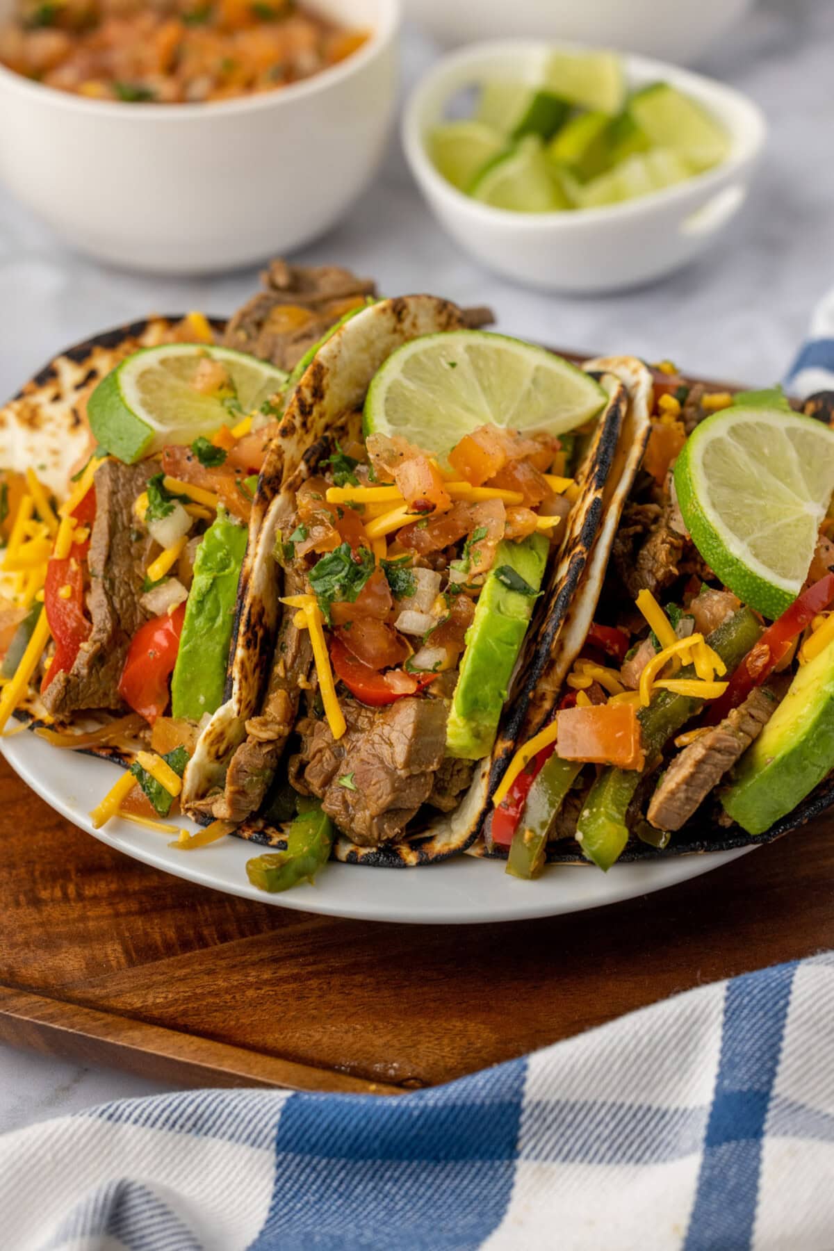 Steak Fajitas wrapped in tortillas served on a plate