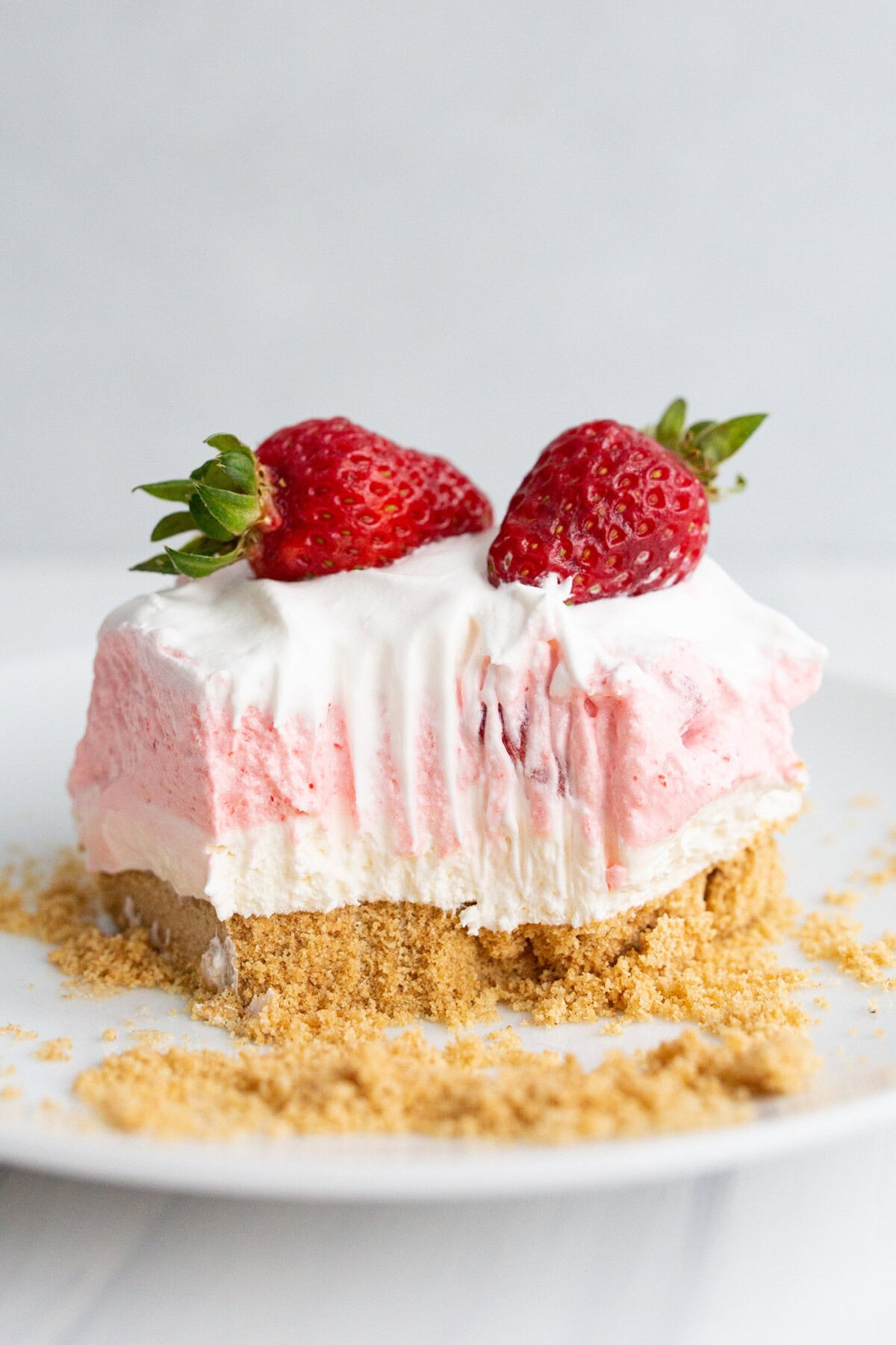 Square of Strawberry Lasagna on a plate with a bite taken out