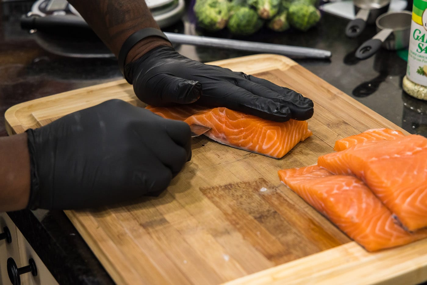 slicing into salmon with a paring knife