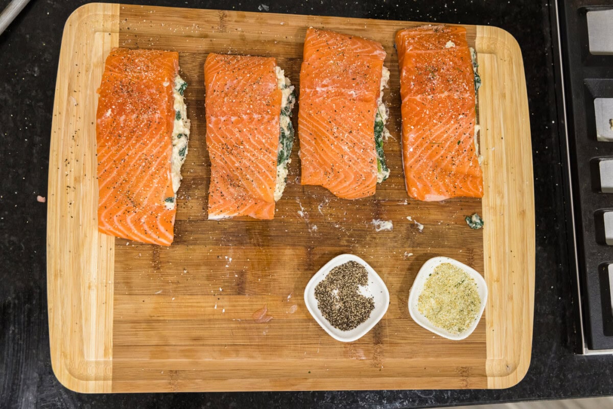 stuffed salmon filets on a cutting board