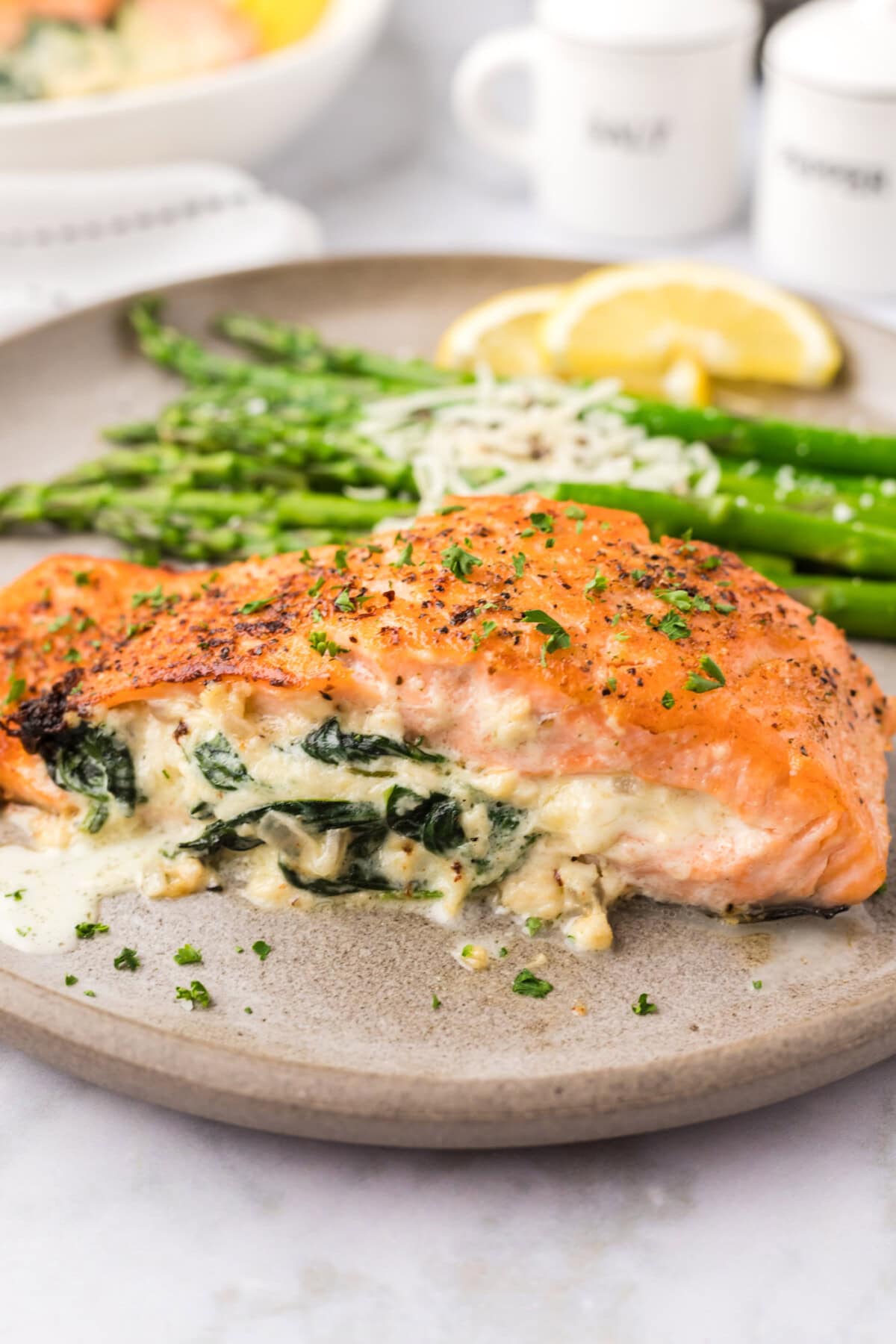 Close up photo of Stuffed Salmon on a plate with asparagus