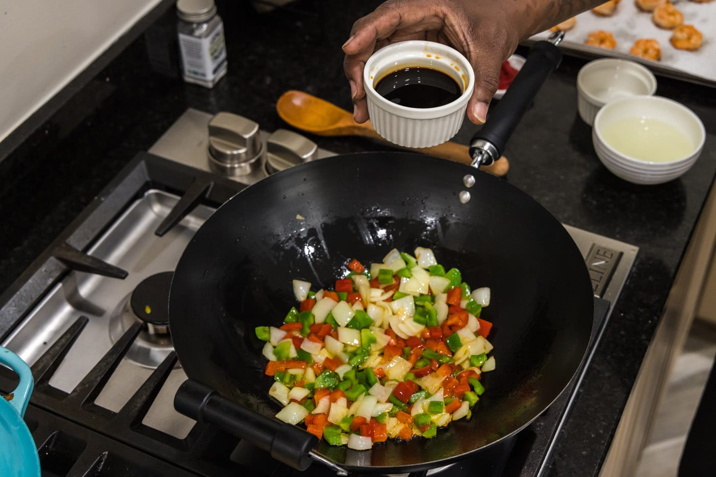 adding soy sauce to skillet