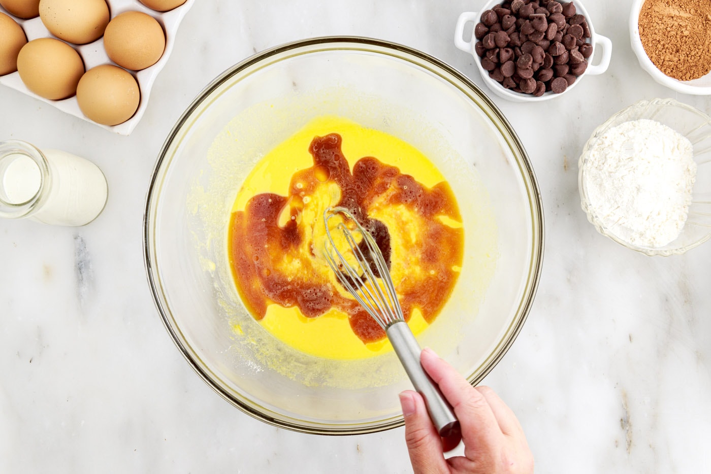 whisking vanilla, egg yolks, and oil in a bowl