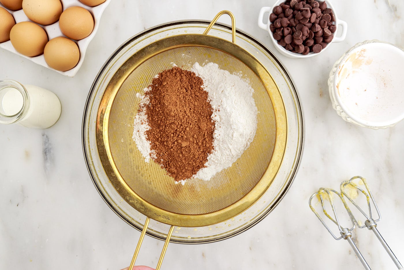 sifting cocoa powder and cake flour into a bowl