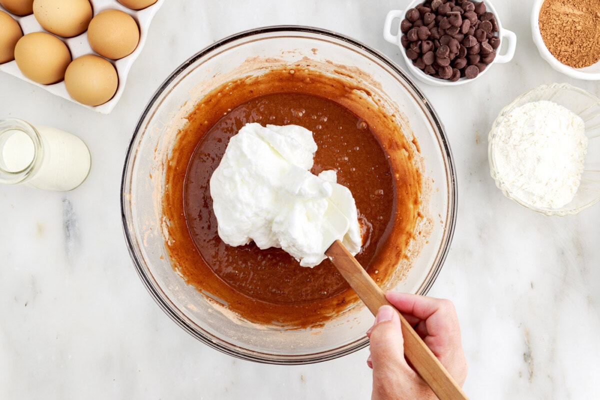 folding egg white mixture into chocolate cake batter
