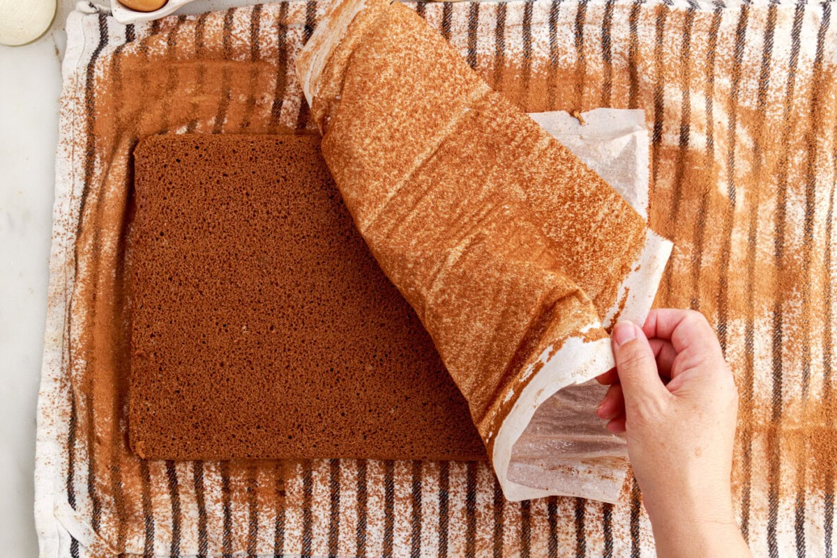 placing jelly roll cake onto towel