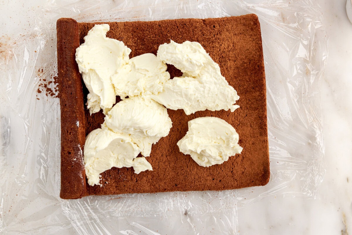 buttercream frosting over swiss log cake