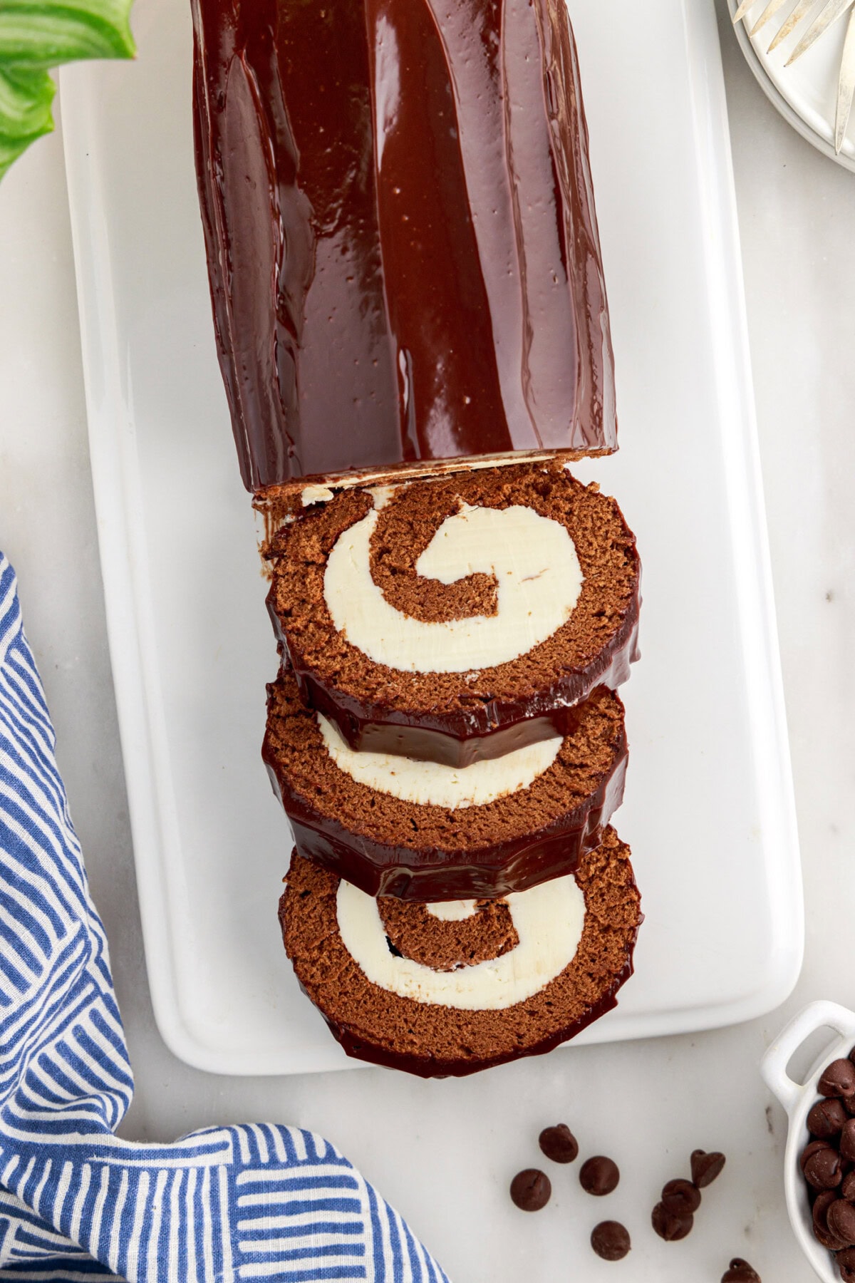 Swiss Roll and three slices on a white platter