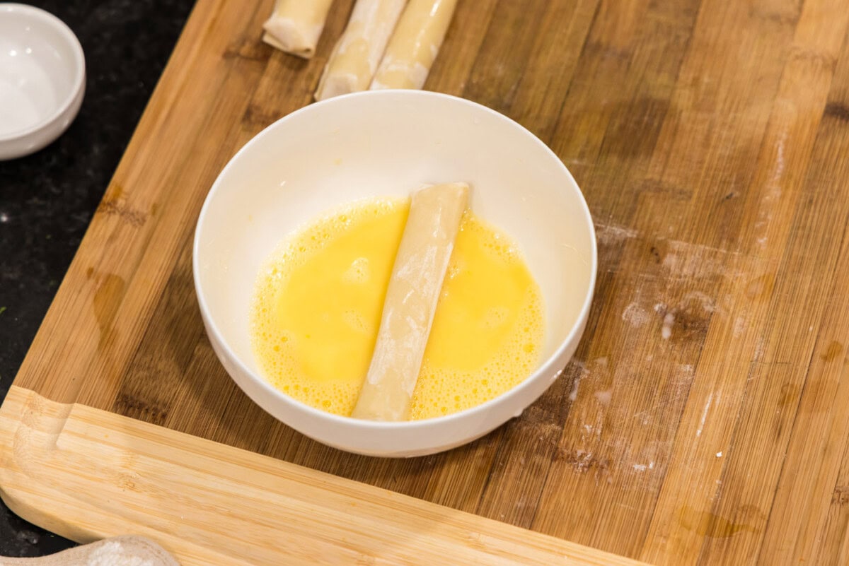 rolling wonton cheese stick in egg wash