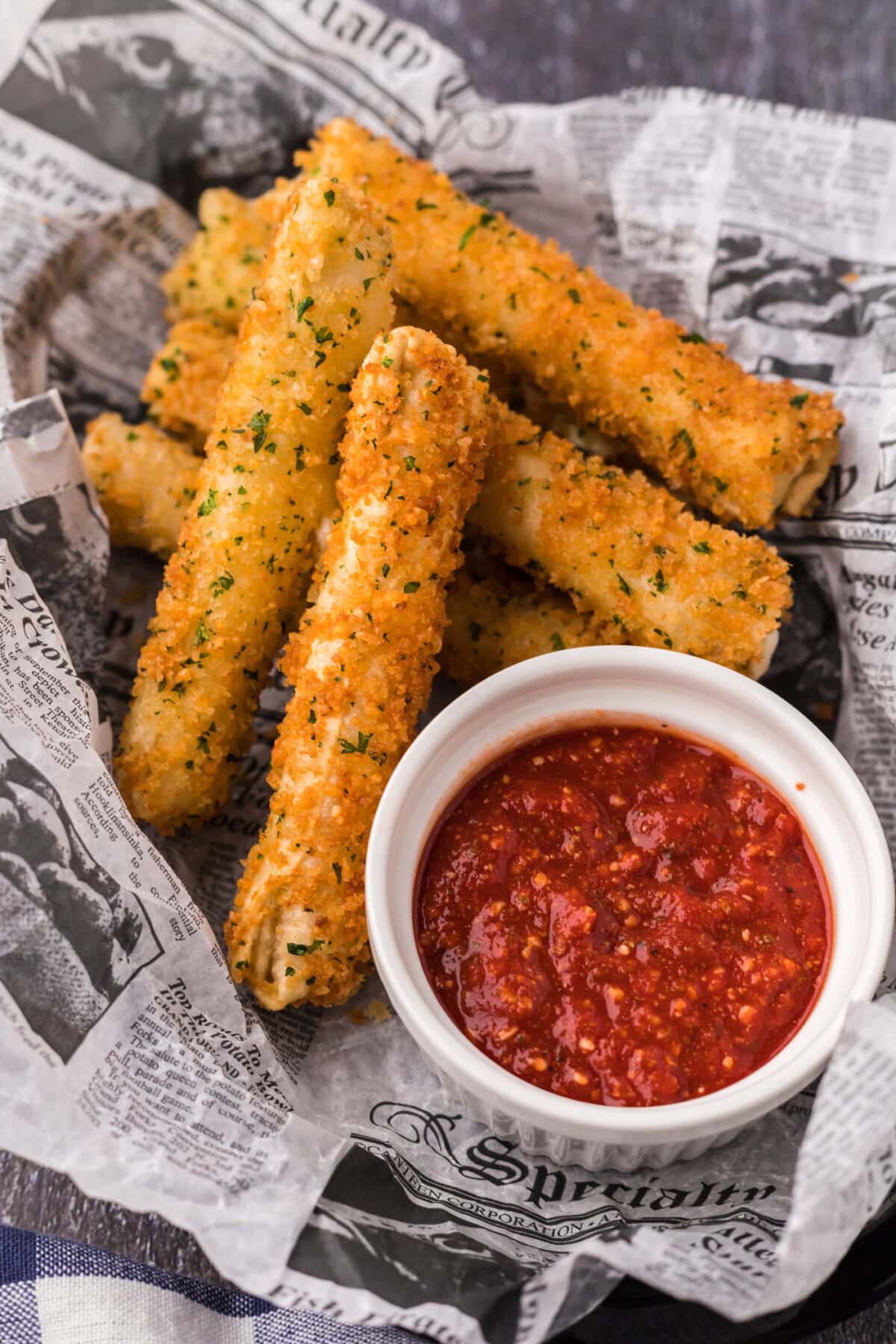 Basket of Wonton Cheese Sticks with a cup of marinara sauce