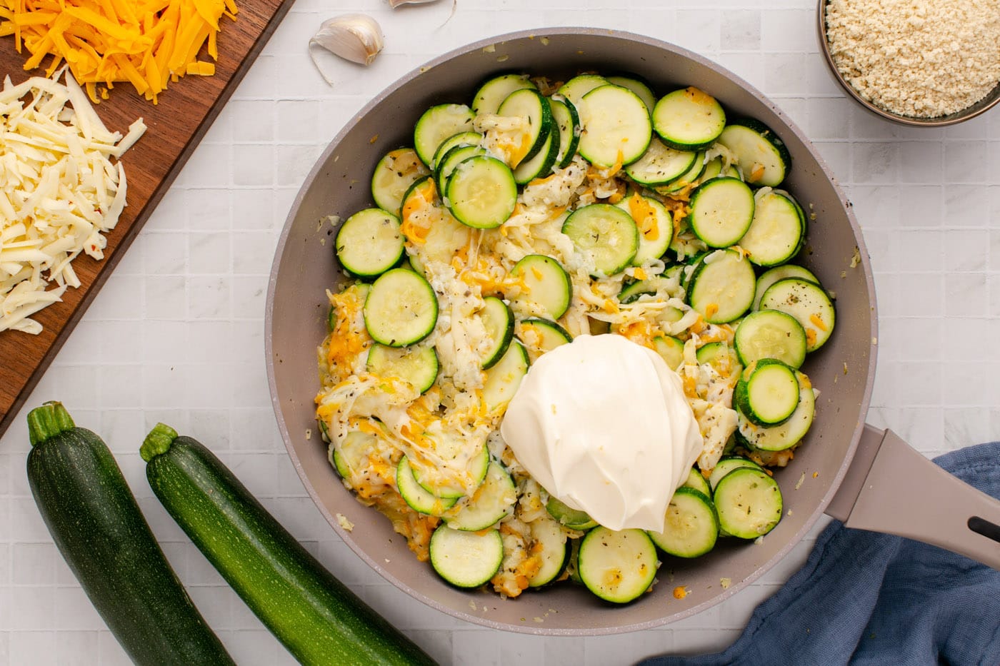 cheesy zucchini mixture in skillet with mayo