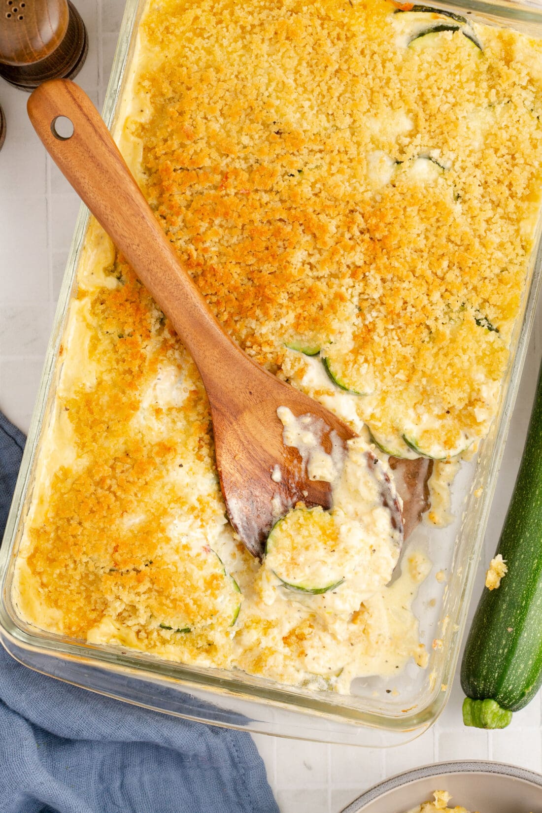 Spoon resting in a pan of Zucchini Casserole