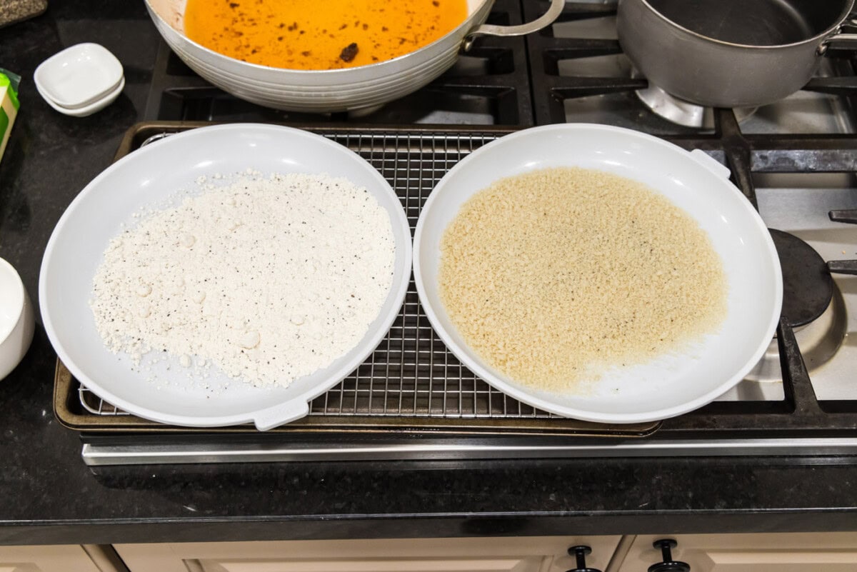 breadcrumbs on a plate next to flour mixture on a plate for dredging