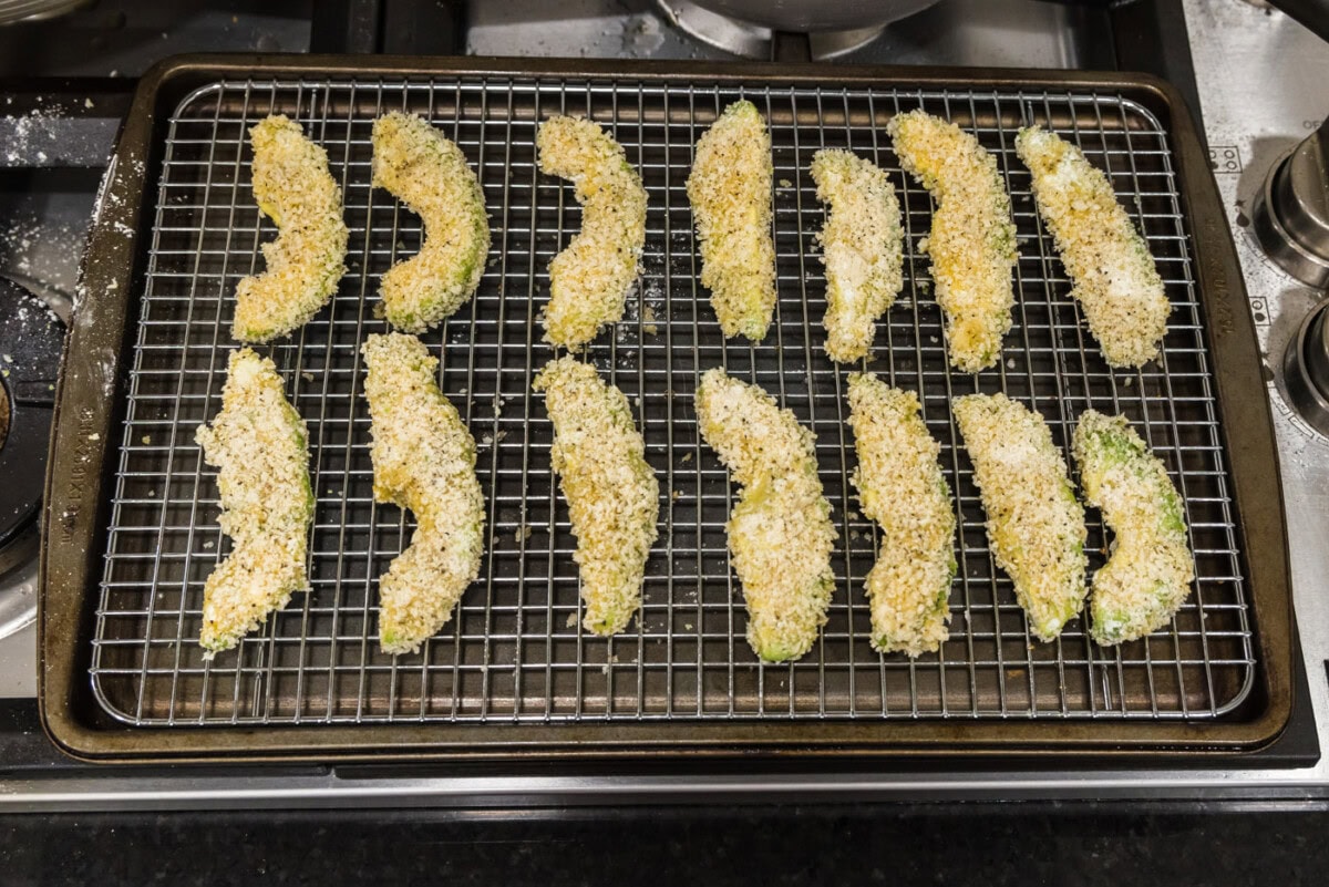 panko breadcrumb coated avocado slices on a wire rack