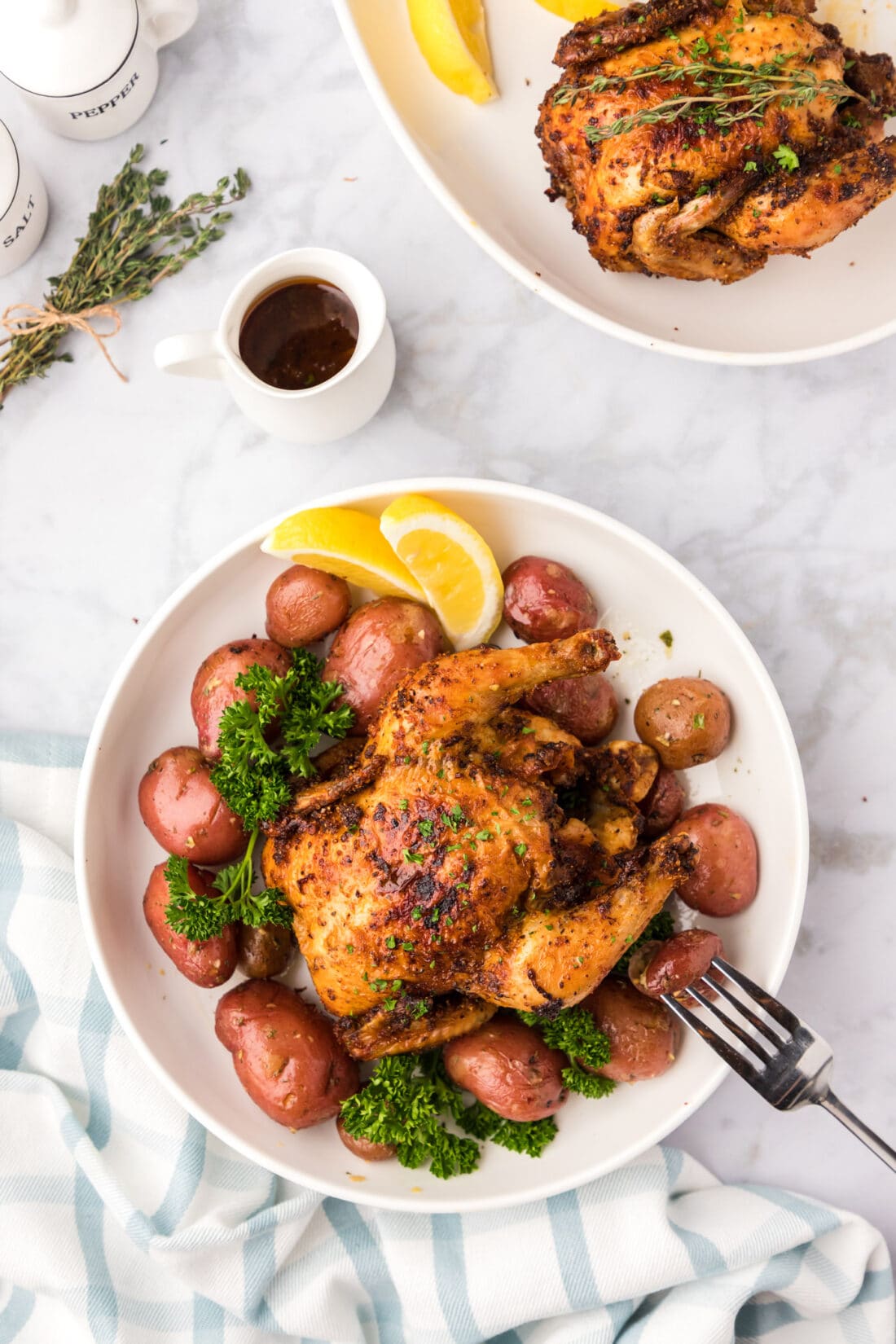 Air Fryer Cornish Hen on a bed of potatoes