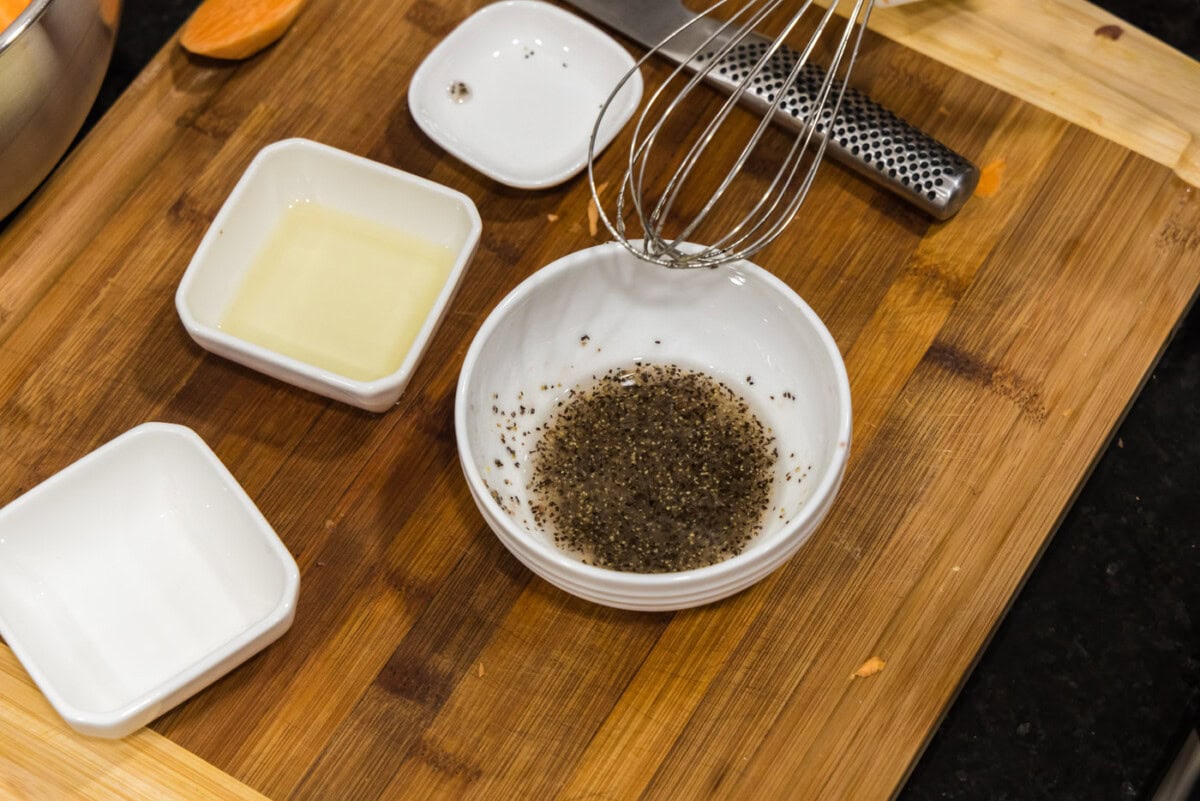 whisking oil mixture in a bowl