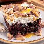 Piece of Better Than Sex Cake on a plate with a fork