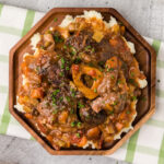 Braised Beef Shanks plated over mashed potatoes