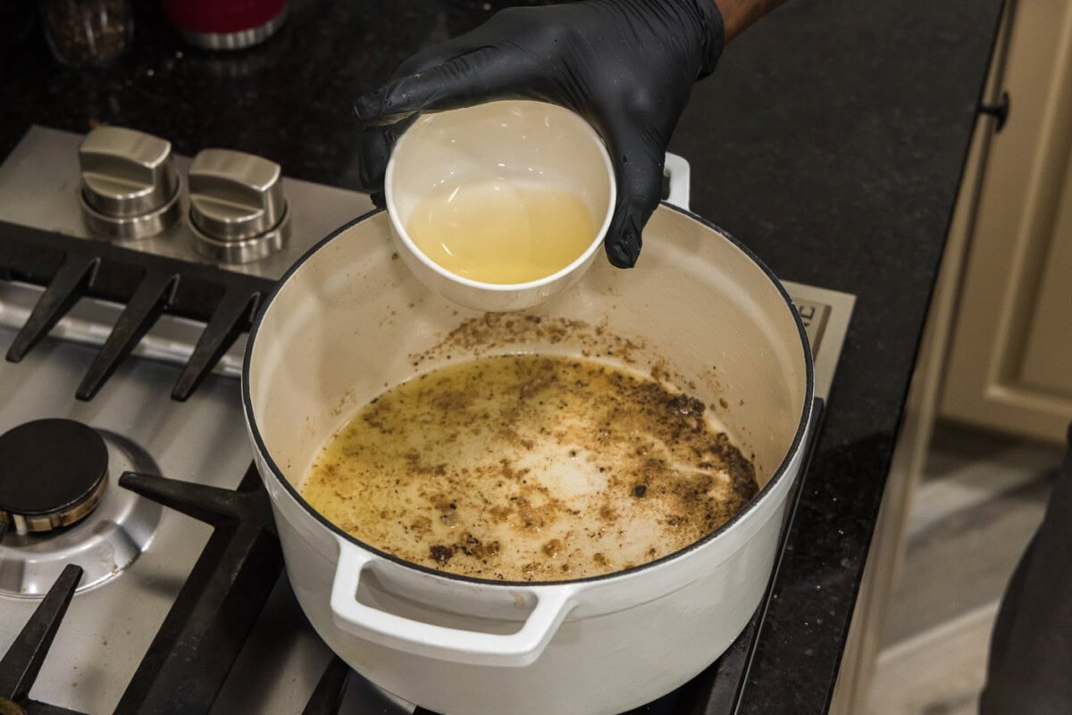 adding white wine to deglaze pan