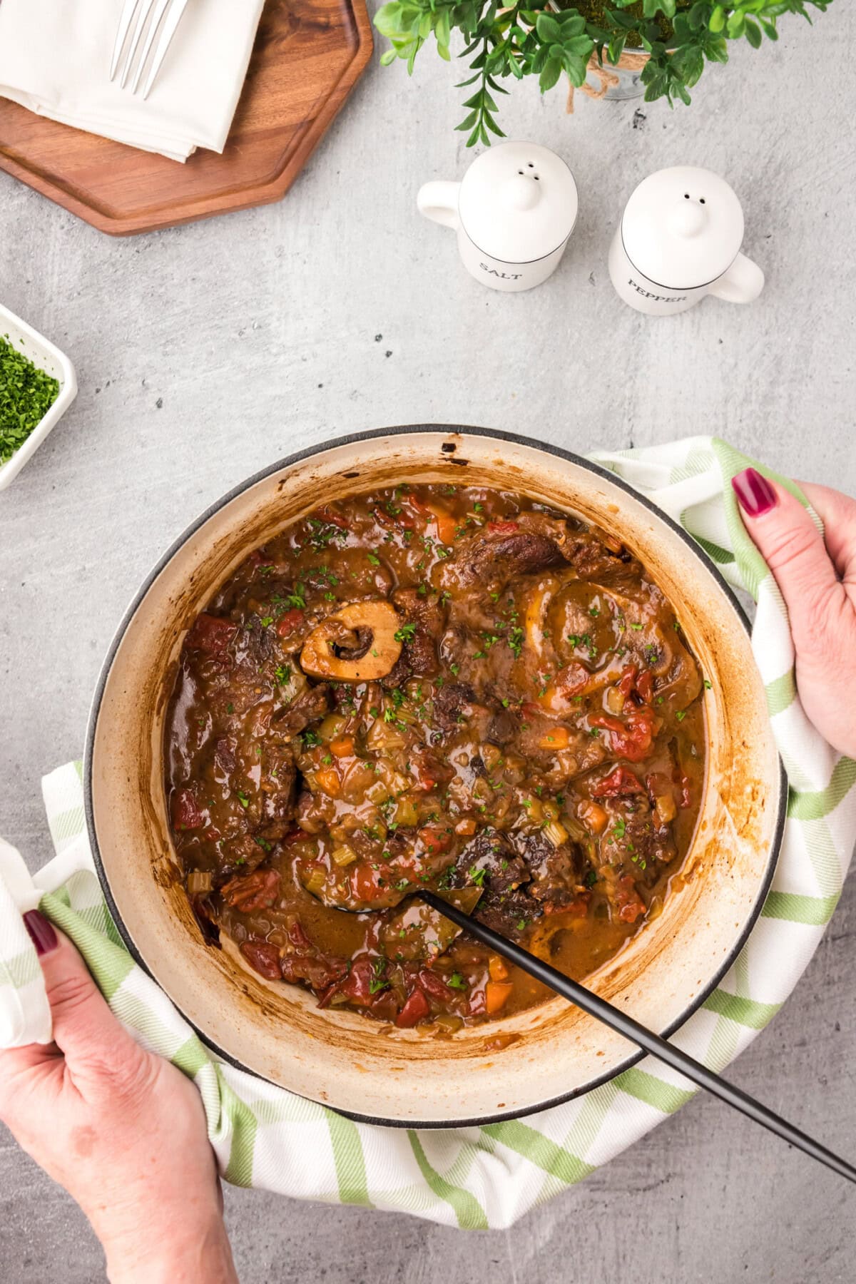 Hands holding a pot of Braised Beef Shanks
