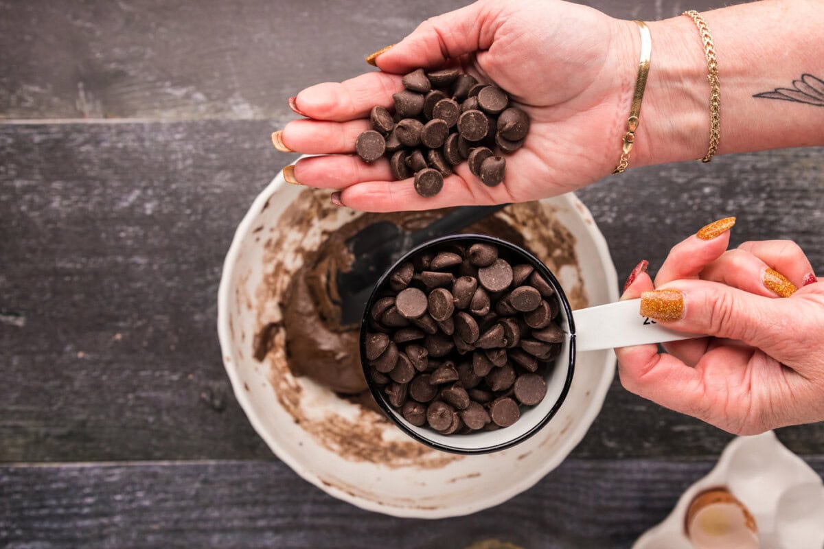 adding dark chocolate chips to brownie mix batter