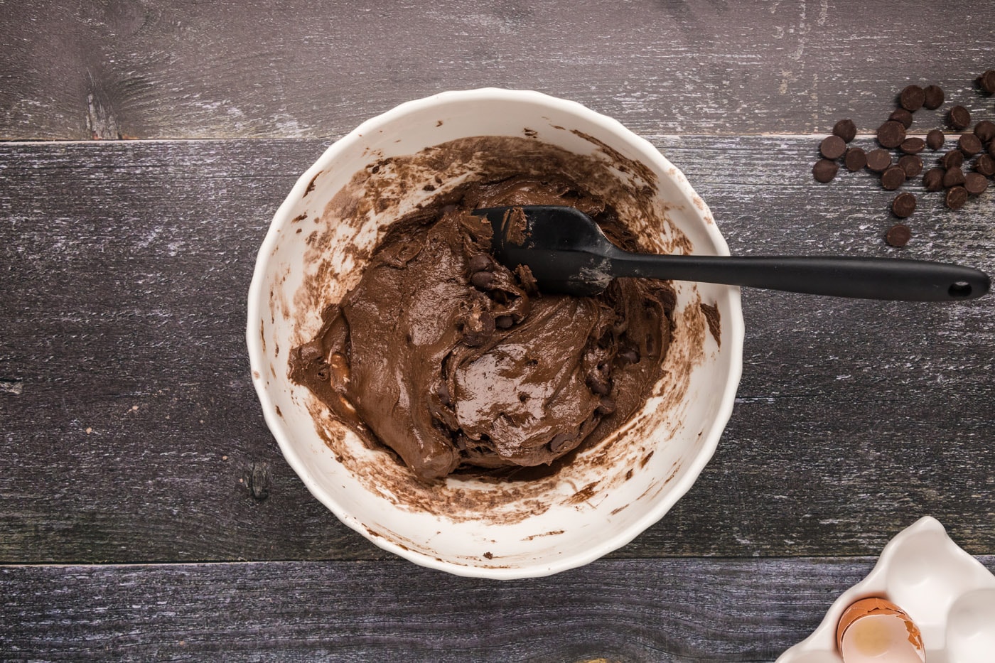 brownie batter in a bowl with dark chocolate chips