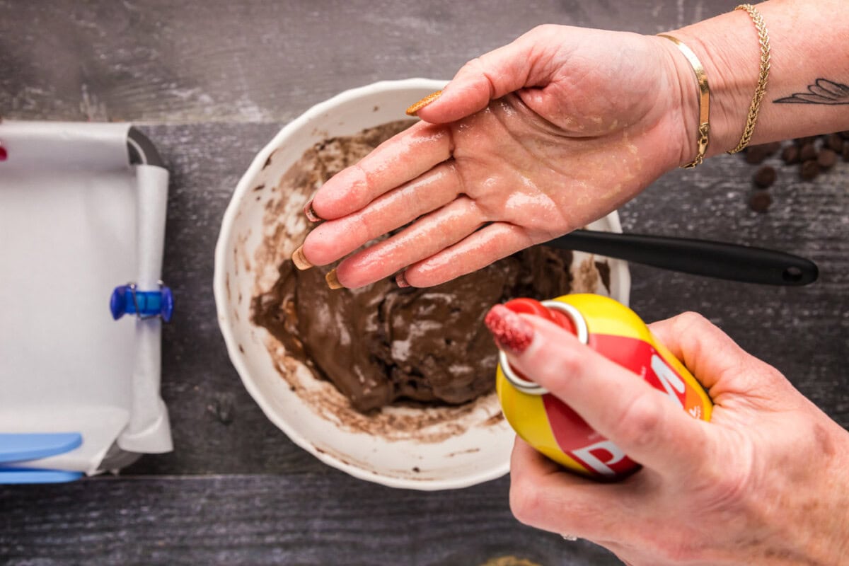 spraying hands with cooking spray