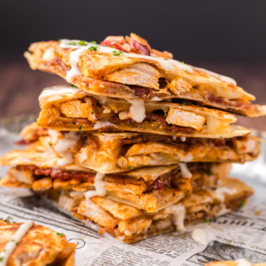 Close up photo of a stack of Chicken Bacon Ranch Quesadilla triangles