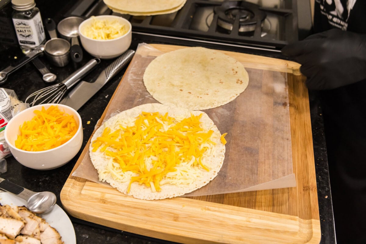 cheddar and mozzarella cheese on top of tortilla