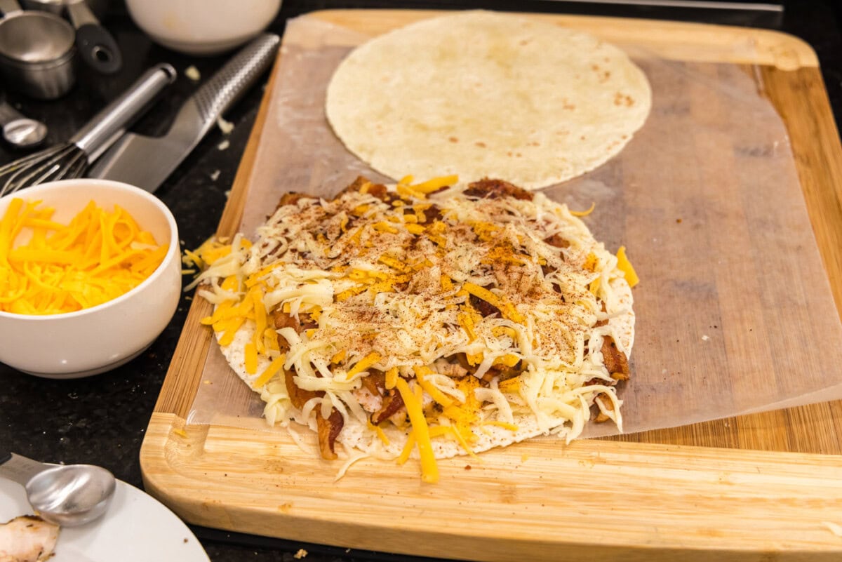 chili powder sprinkled over chicken bacon ranch tortilla