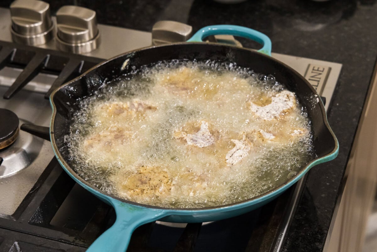 dredged chicken frying in oil
