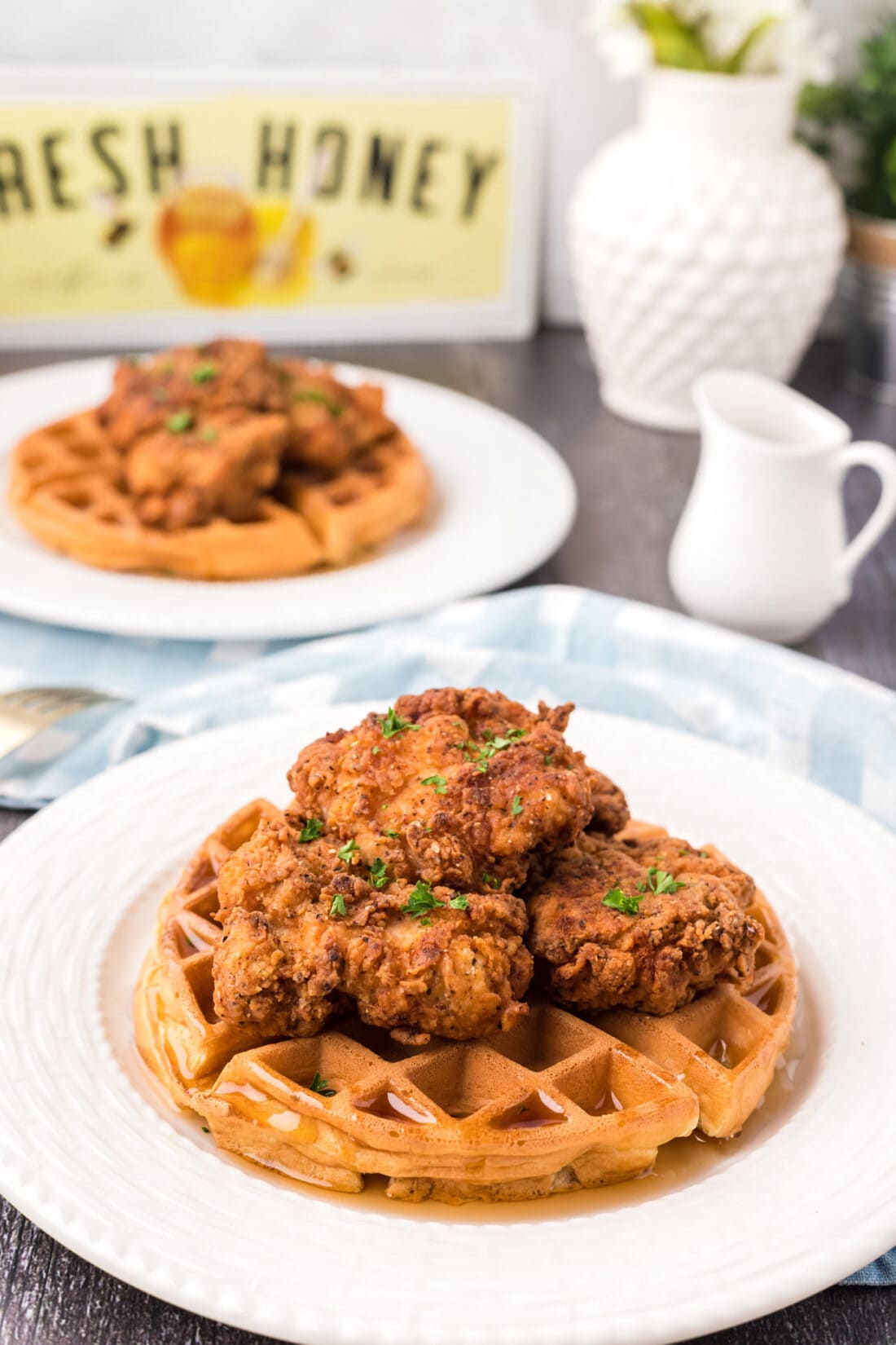 Two plates of Chicken and Waffles
