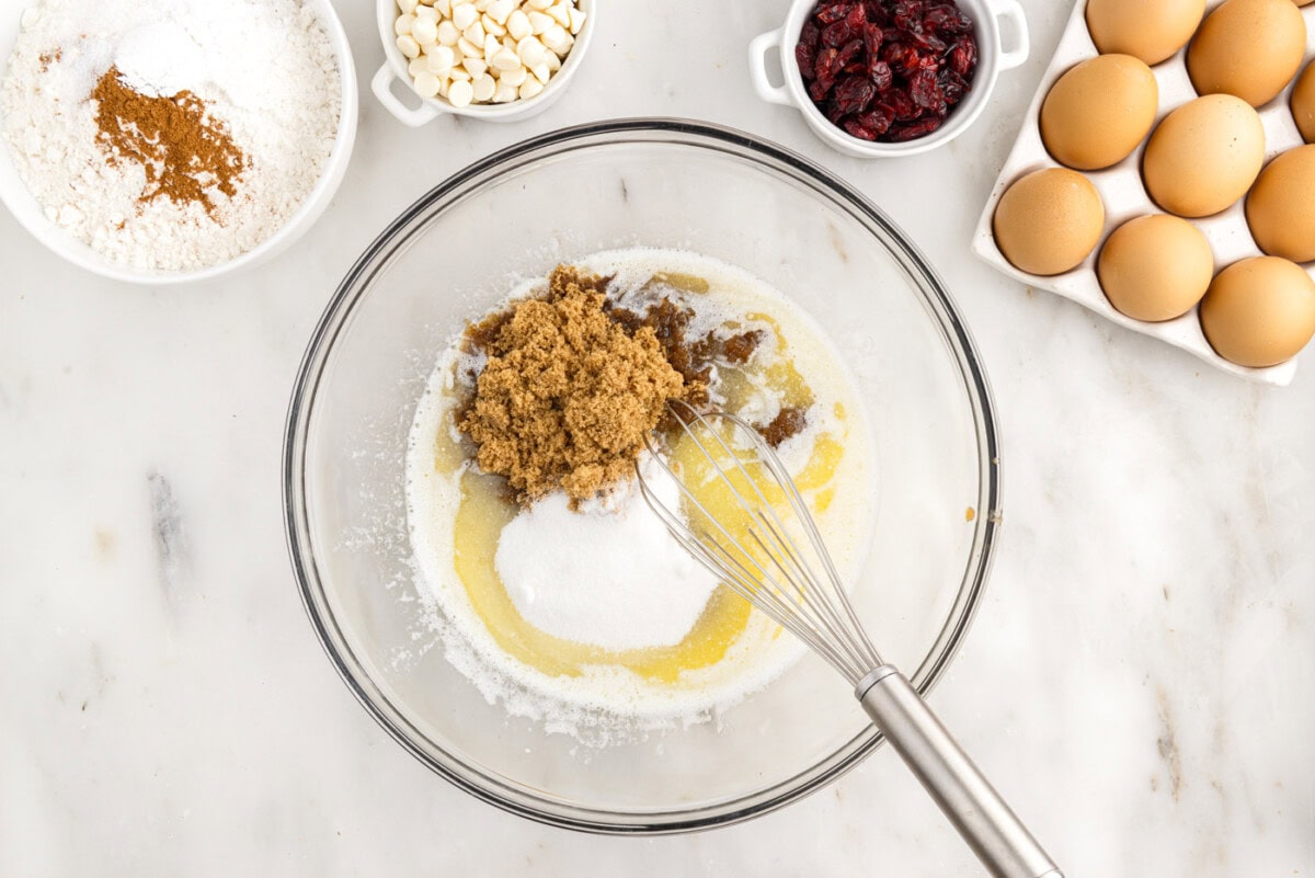 melted butter and sugars in a bowl with a whisk