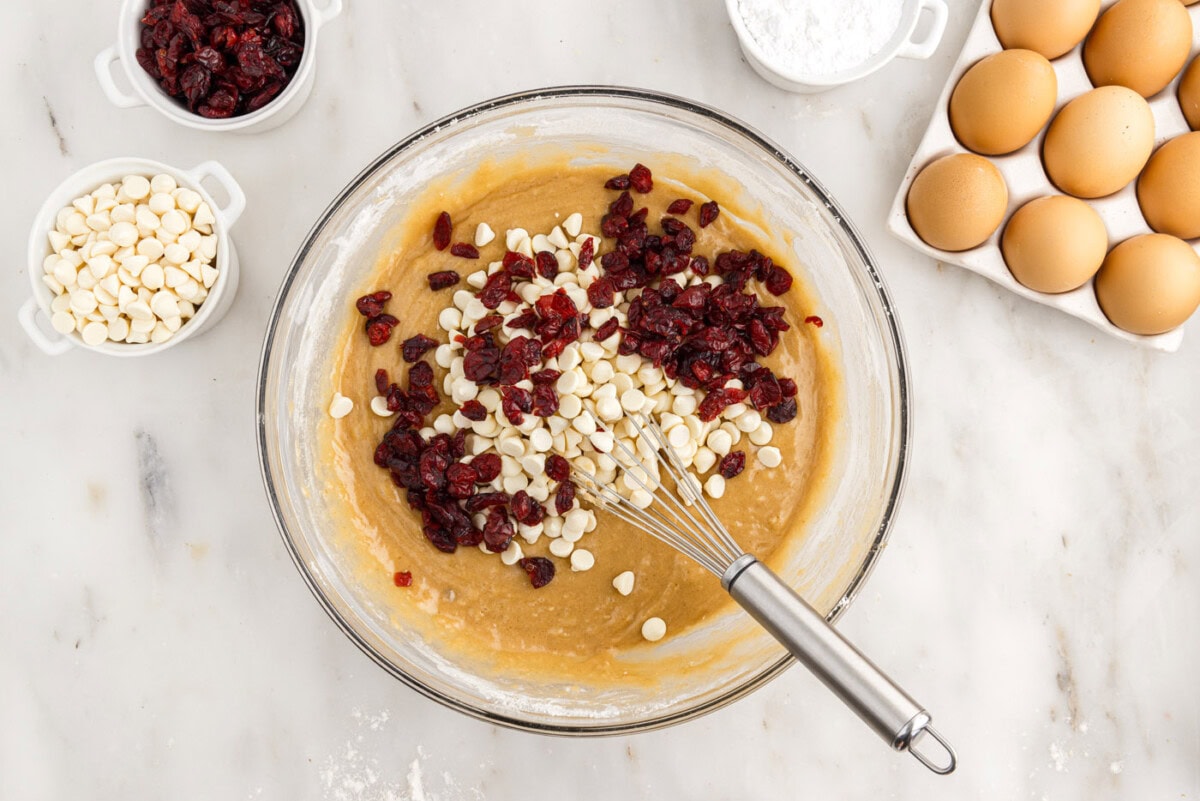 adding dried cranberries and white chocolate chips to blondie batter