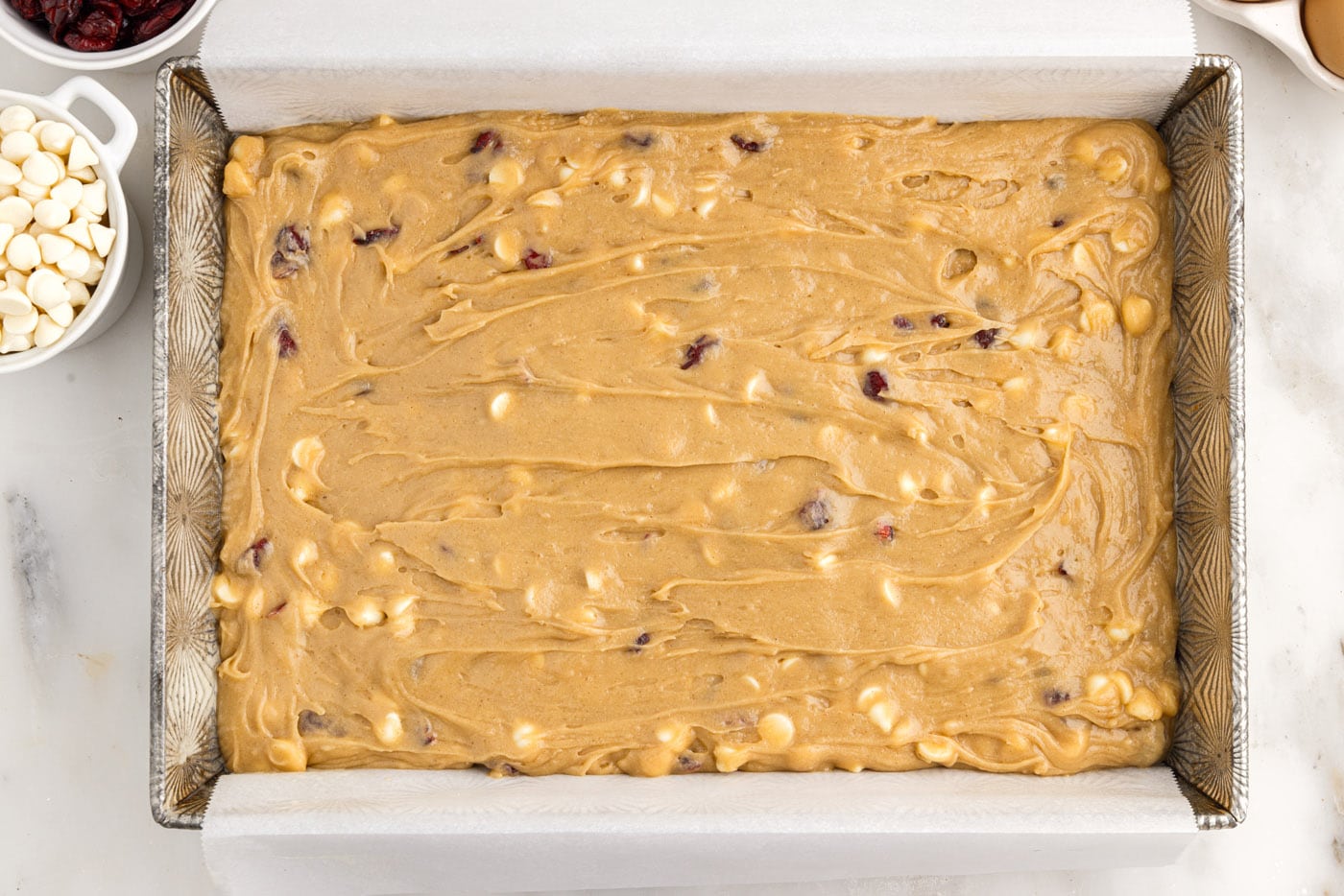 white chocolate cranberry blondies in a baking pan