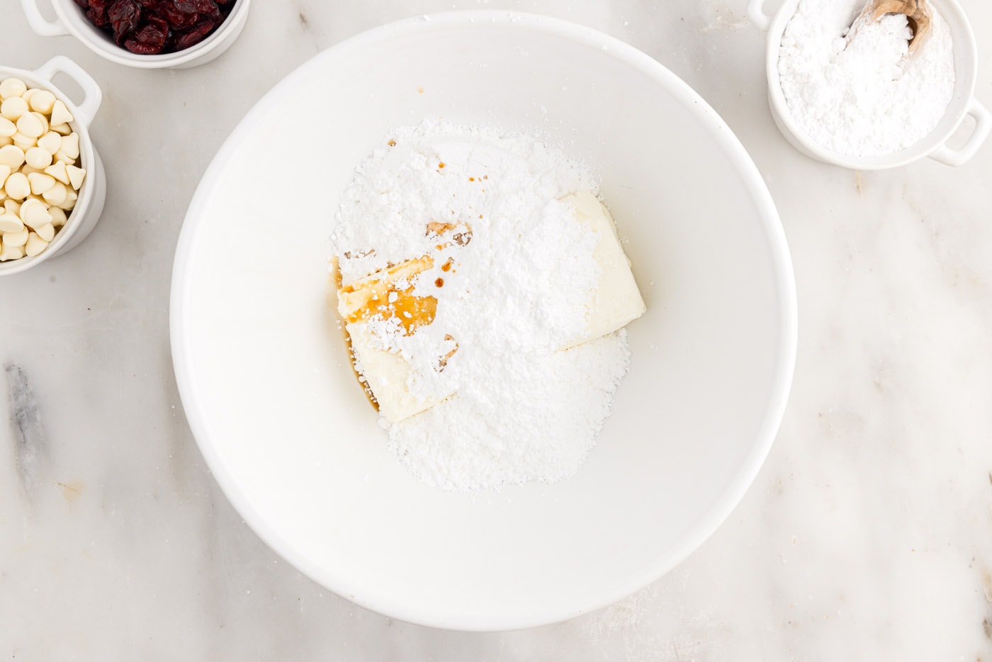 powdered sugar, cream cheese, and orange oil in a mixing bowl