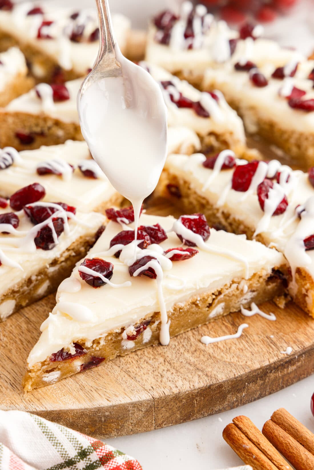 White chocolate bring drizzled over a Cranberry Bliss Bar
