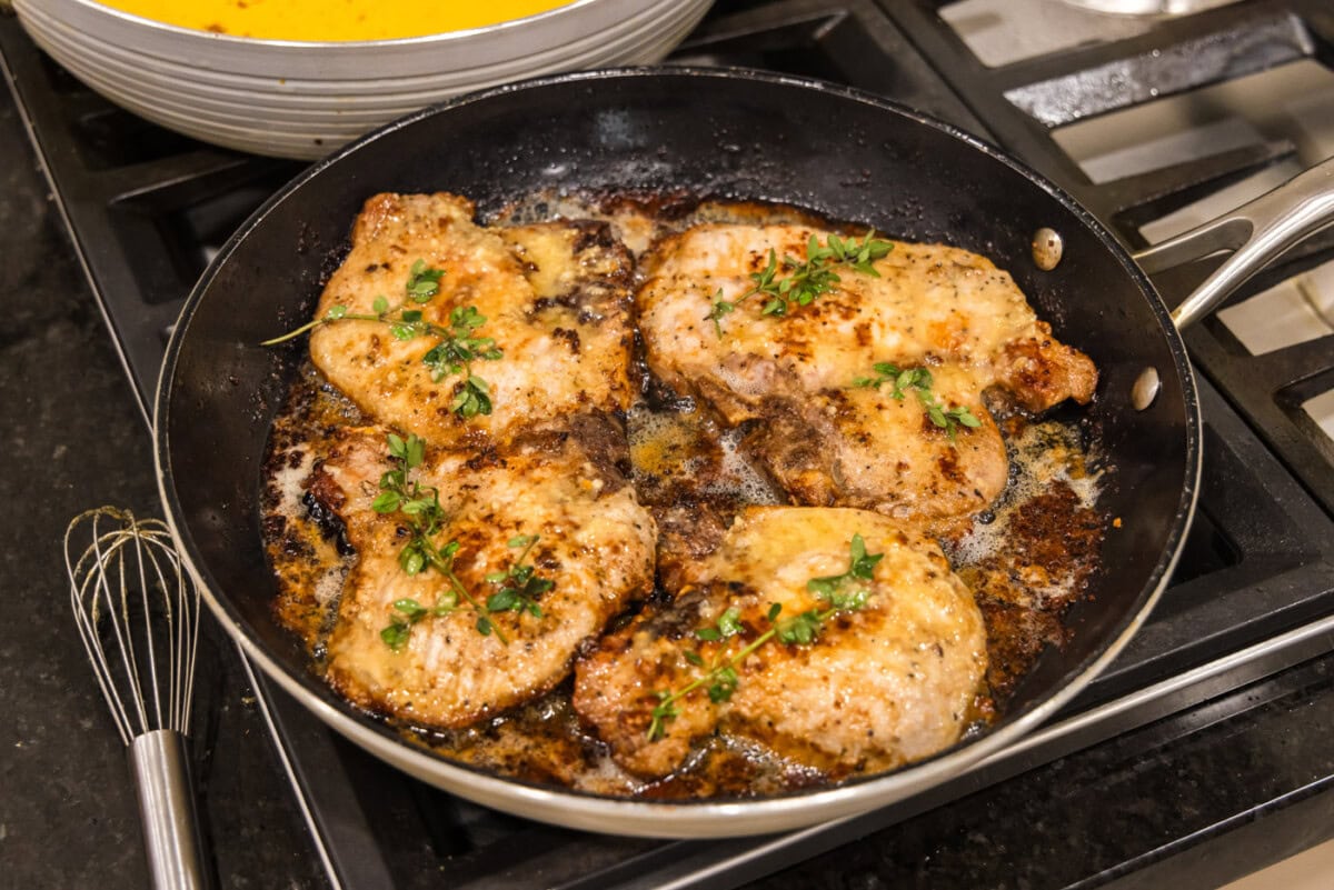 finished garlic butter pork chops in a skillet