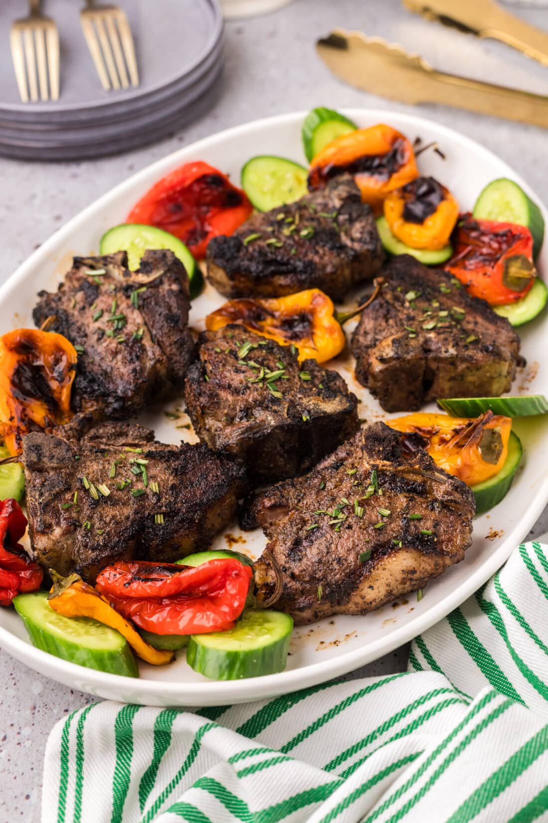 Grilled Lamb Loin Chops on a platter with vegetables