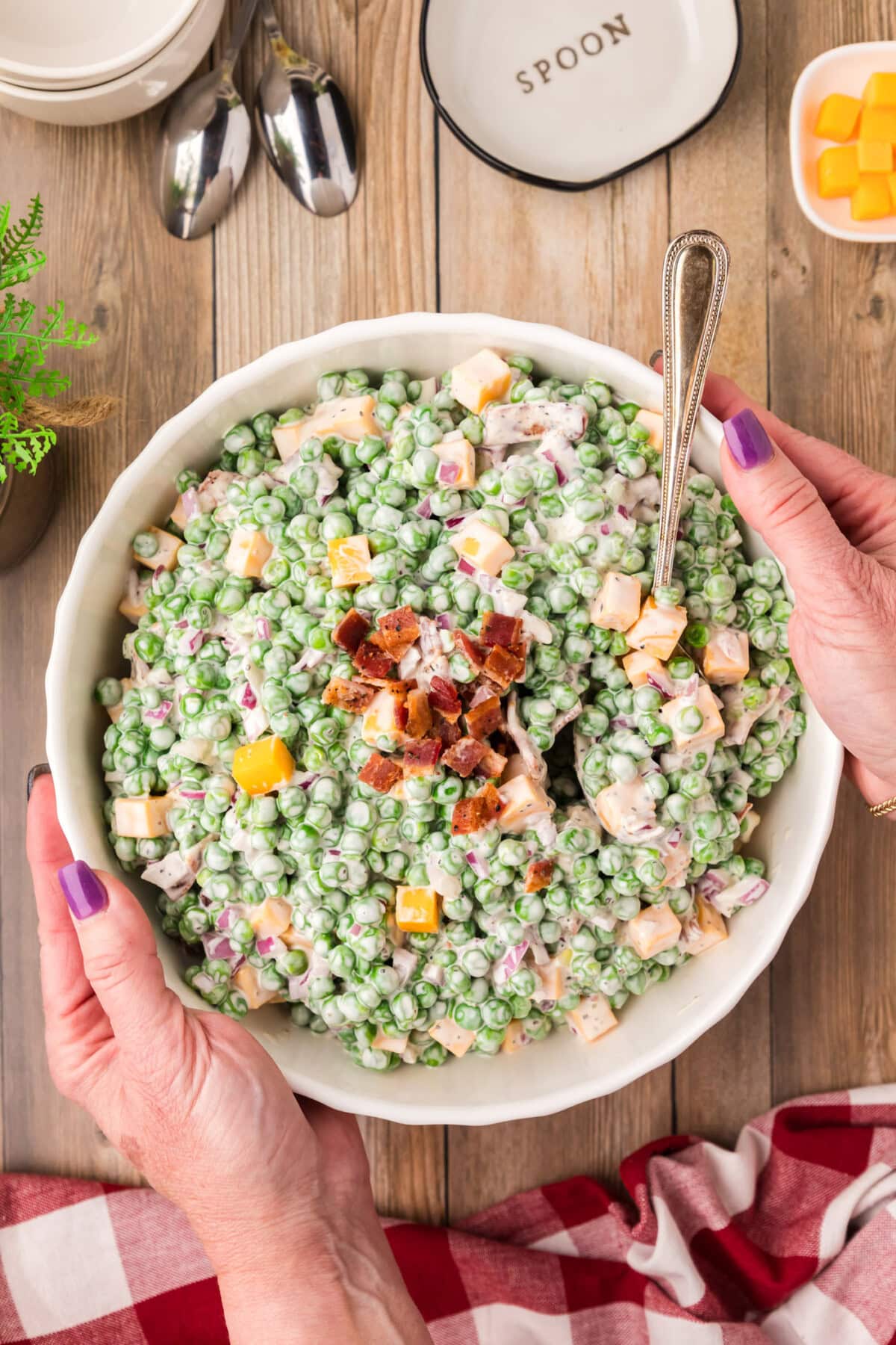 Hands holding a bowl of Pea Salad