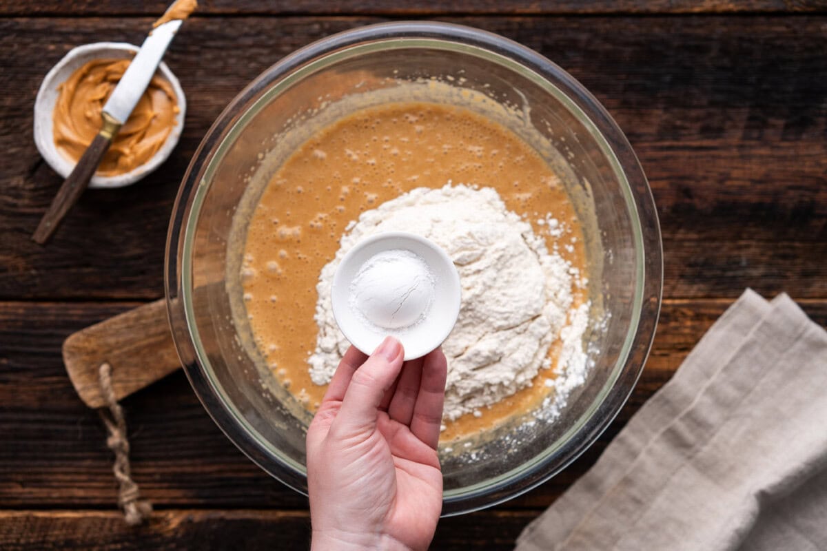 adding flour, baking powder, and salt to peanut butter mixture