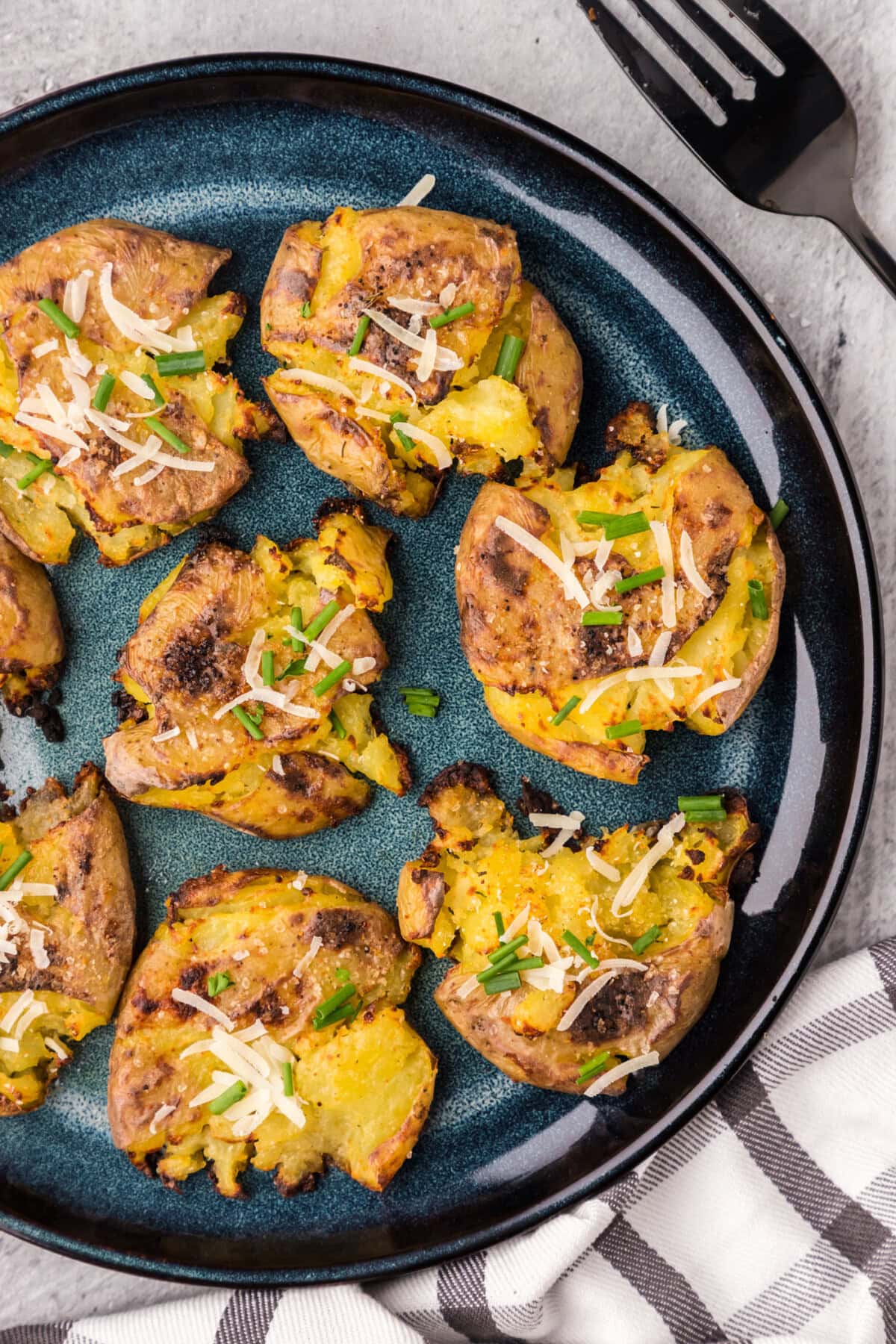 Close up photo of Smashed Potatoes on a blue plate