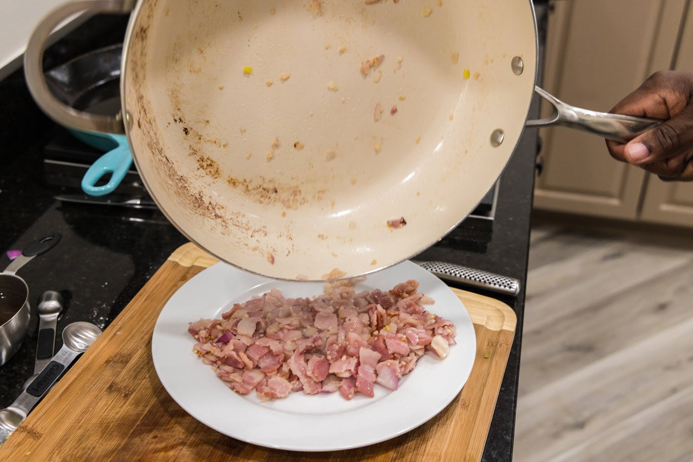 transferring shallot and bacon mixture to a plate