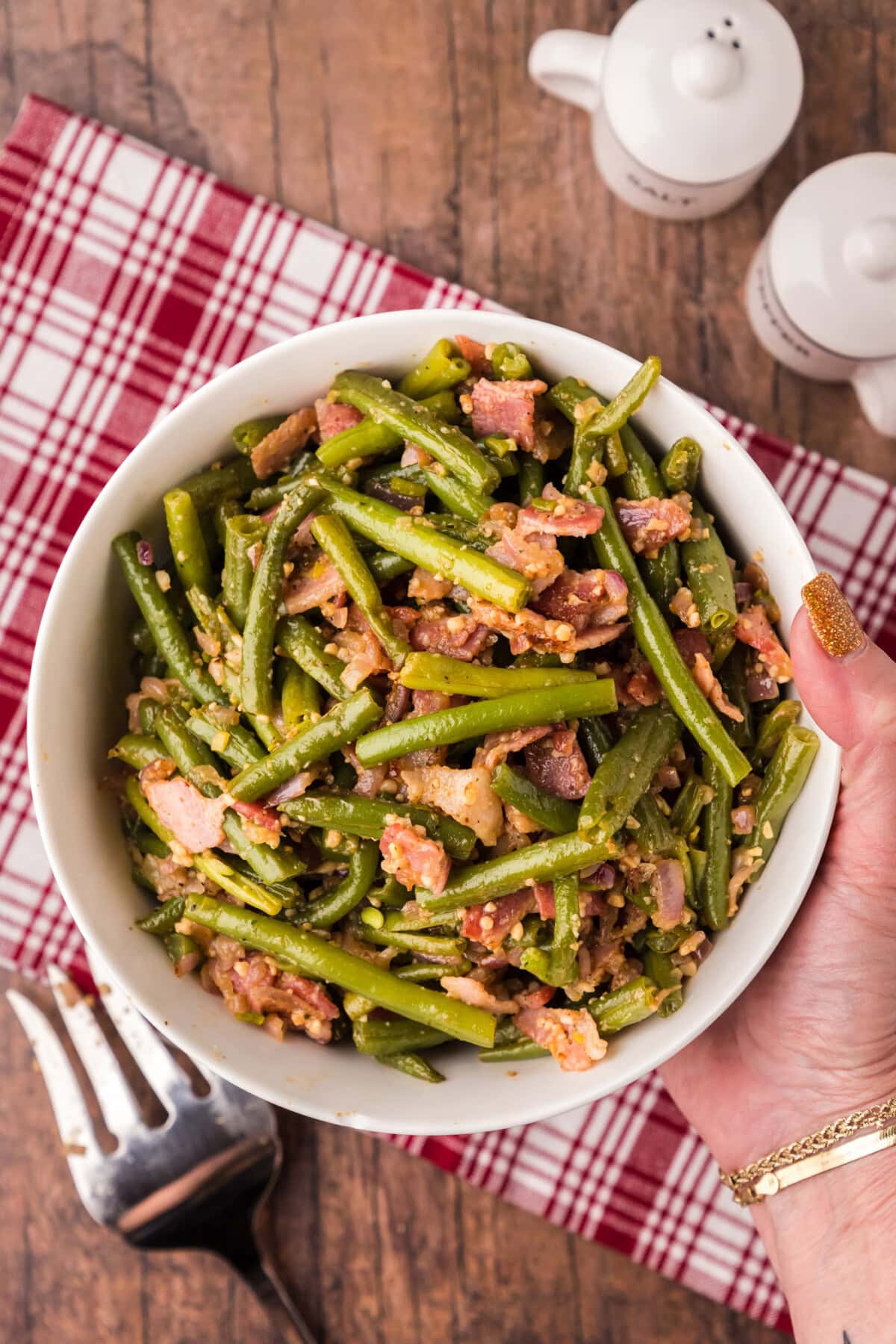 Hand holding a bowl of Southern Green Beans