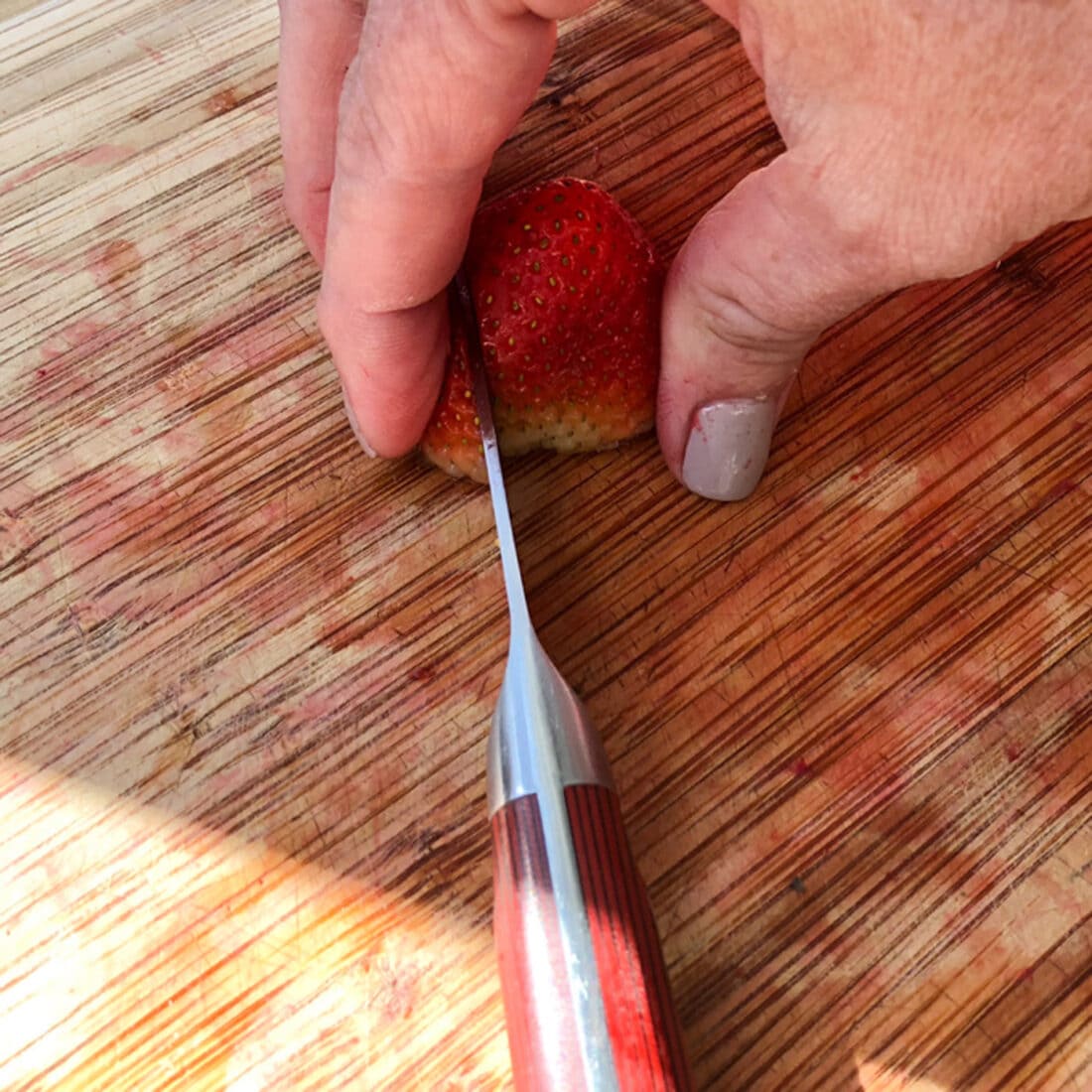 Strawberry being cut into slices