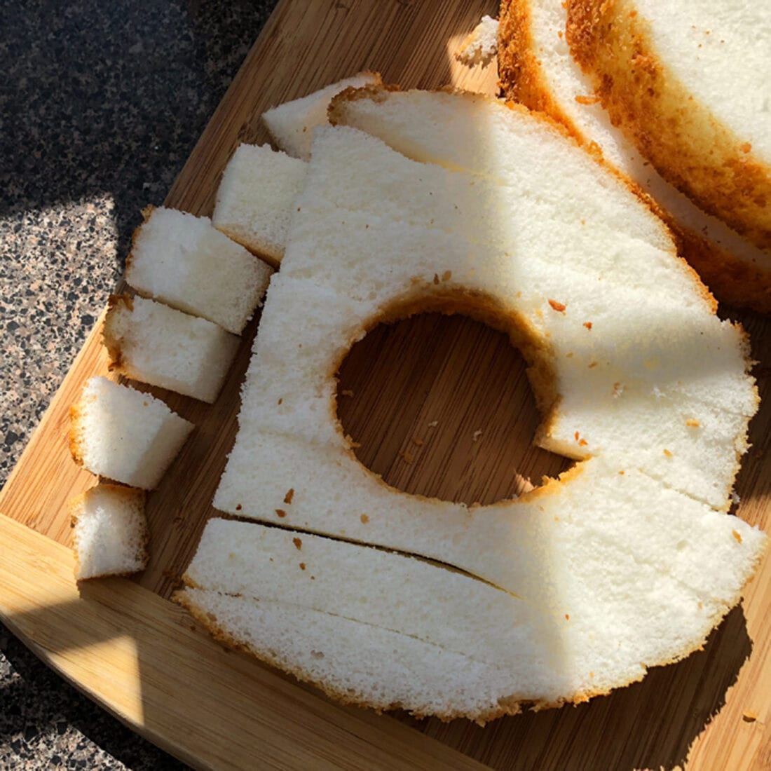 Cutting angel food cake into cubes