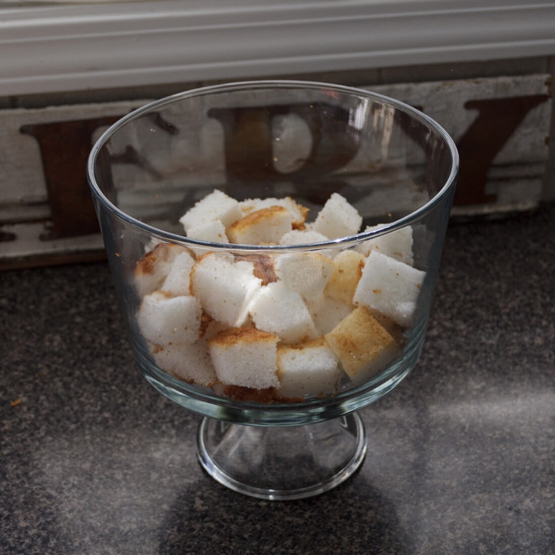 angel food cake cubes in a trifle bowl