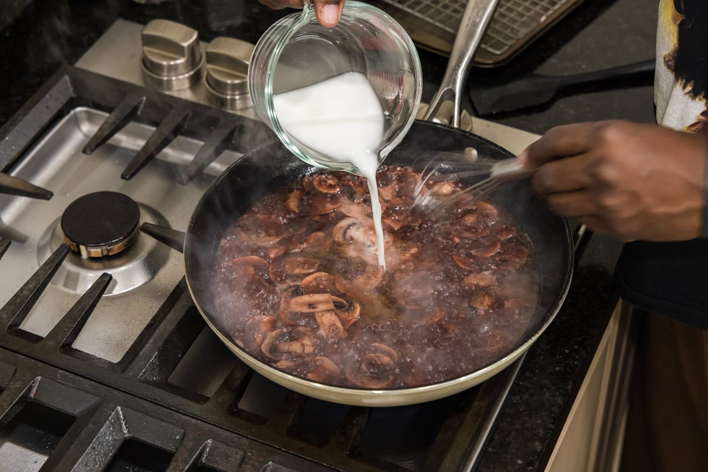 pouring cornstarch slurry into mushroom marsala sauce