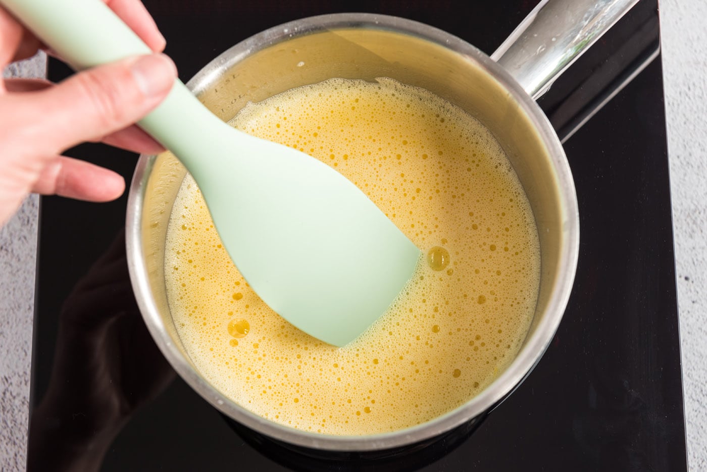 Warmed egg yolk mixture in a saucepan