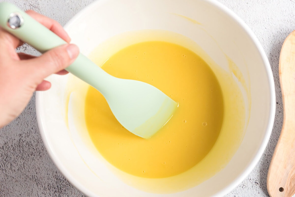 Egg mixture being stirred with white chocolate pieces